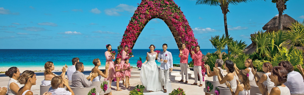 For a us-based couple interested in a destination wedding, why should they focus on all-inclusive resorts in Mexico, the Caribbean, Central America and beyond, and why should they use a travel agent for this 