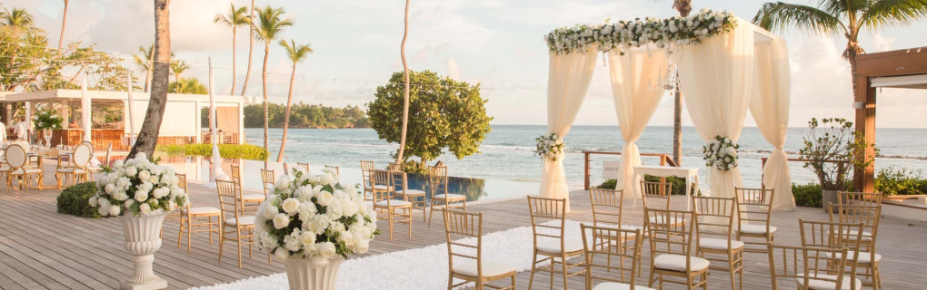 For a us-based couple interested in a destination wedding, why should they focus on all-inclusive resorts in Mexico, the Caribbean, Central America and beyond, and why should they use a travel agent for this 