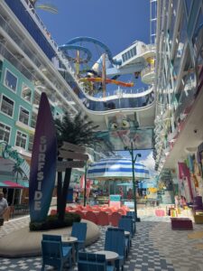 Colorful Surfside family neighborhood on Royal Caribbean's Icon of the Seas featuring water slides, pool, carousel, and staterooms with balconies.