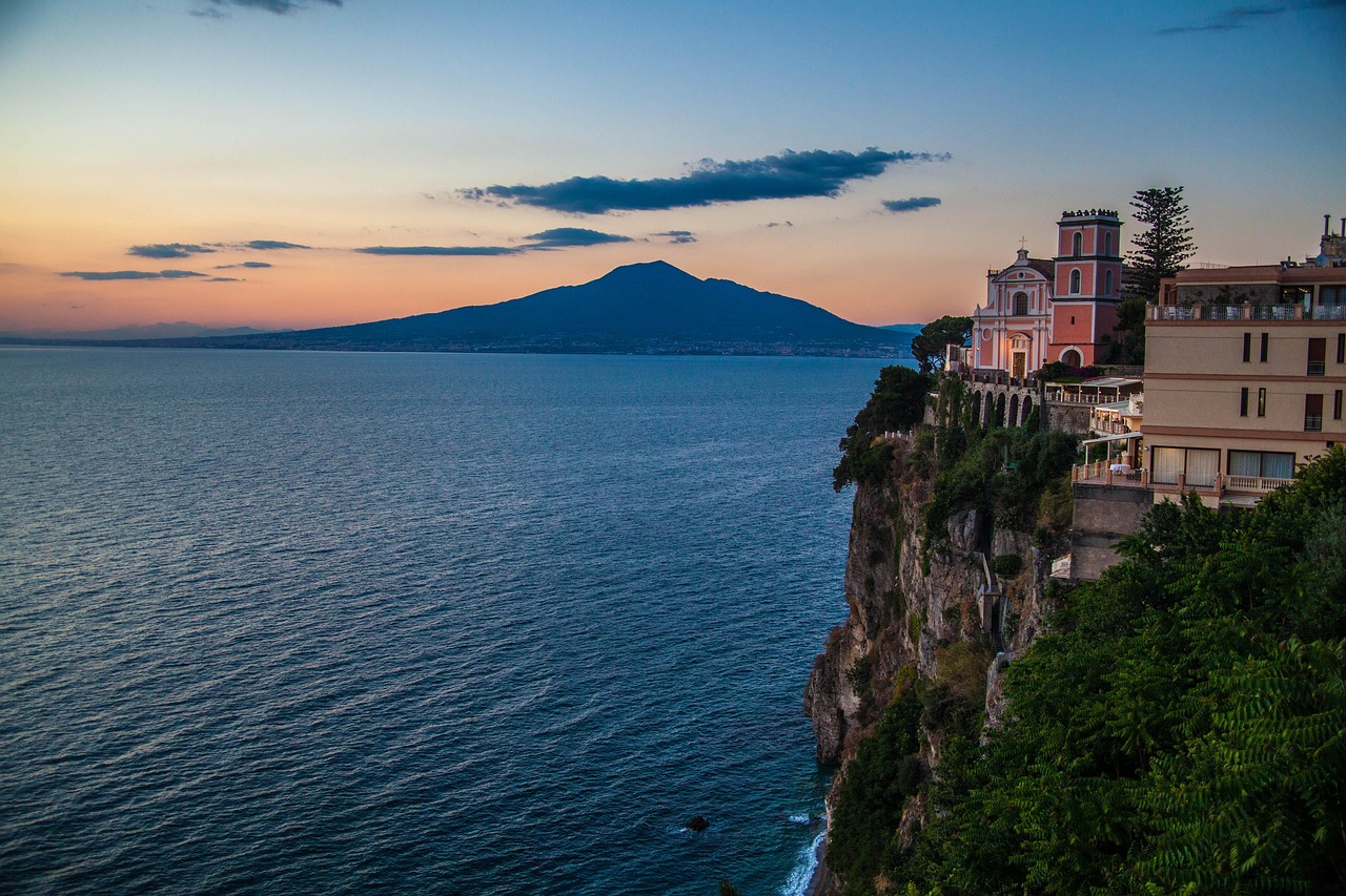 Dramatic sunset over Mediterranean cliffside illustrating sensory travel storytelling