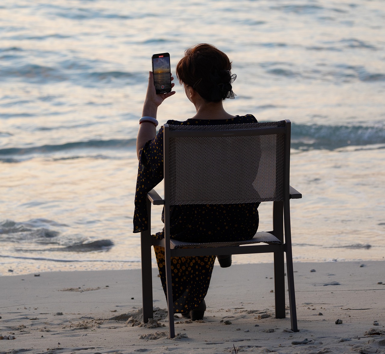 Prospective luxury travel client comfortably browsing travel advisor recommendations and itineraries on a mobile tablet