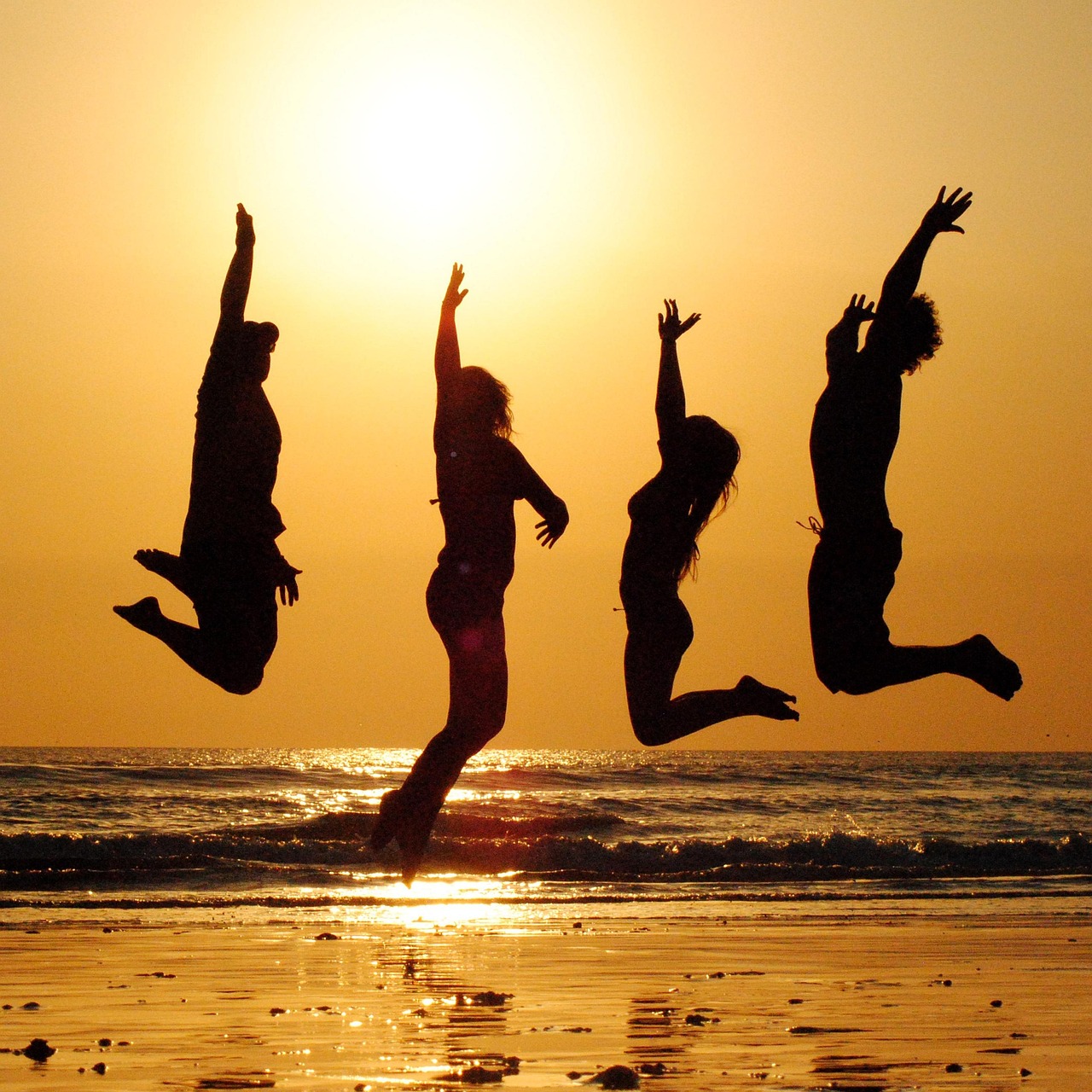 Group of friends and family celebrating vacation reunion on tropical beach organized by travel agent