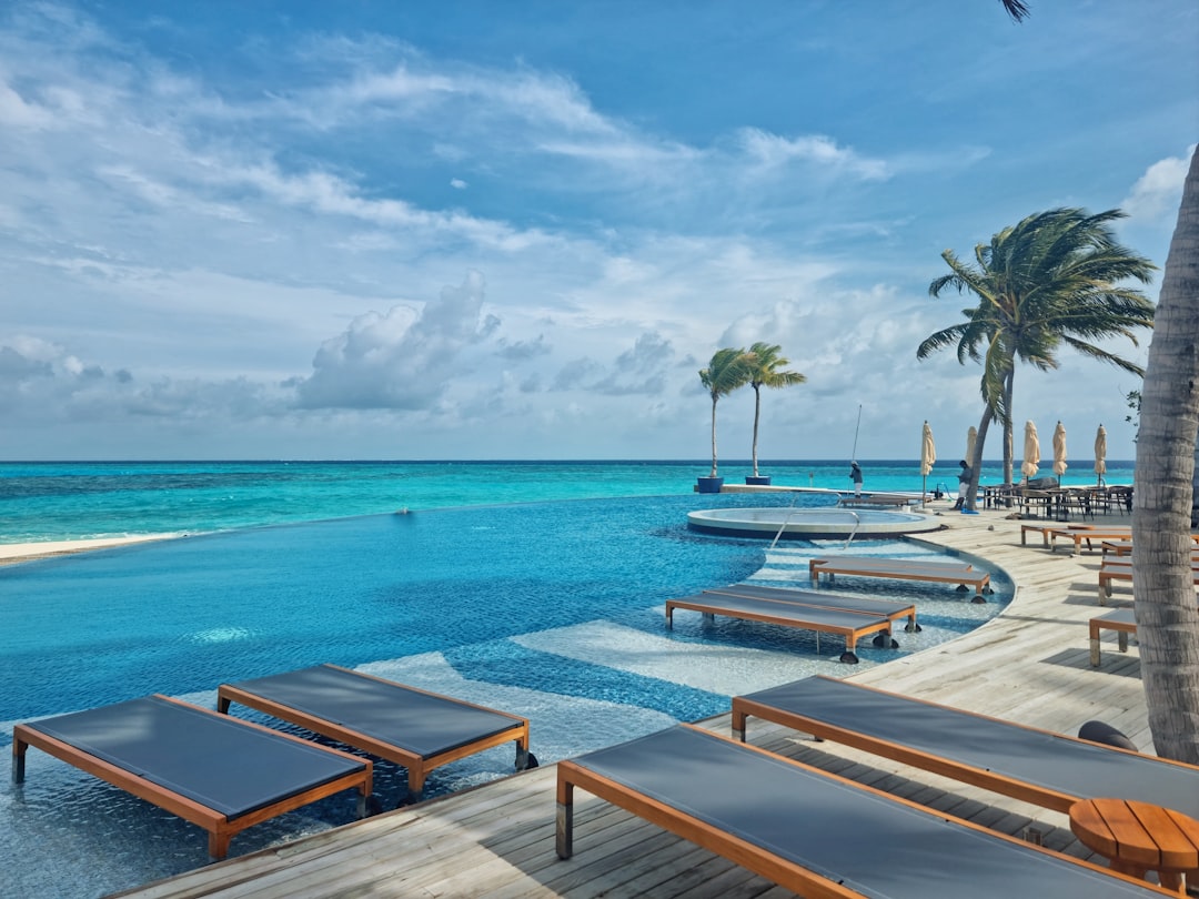 Luxury tropical resort overwater bungalow showcasing resort credit amenities for repeat travel bookings