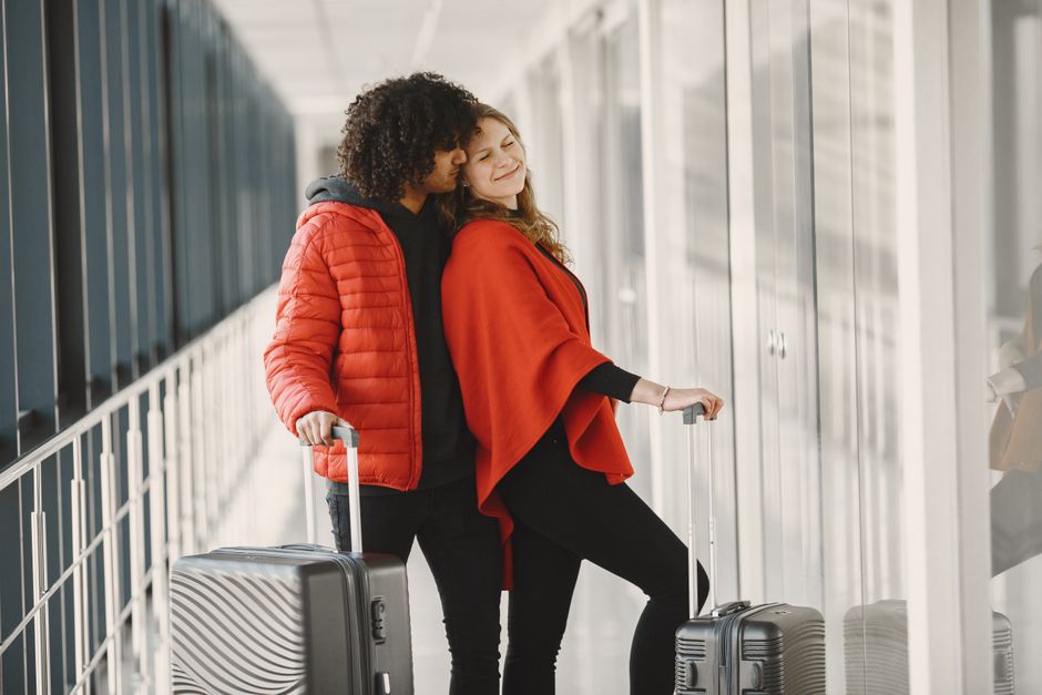 Travel advisor checking in with happy returning clients at airport to capture 5-star Google review