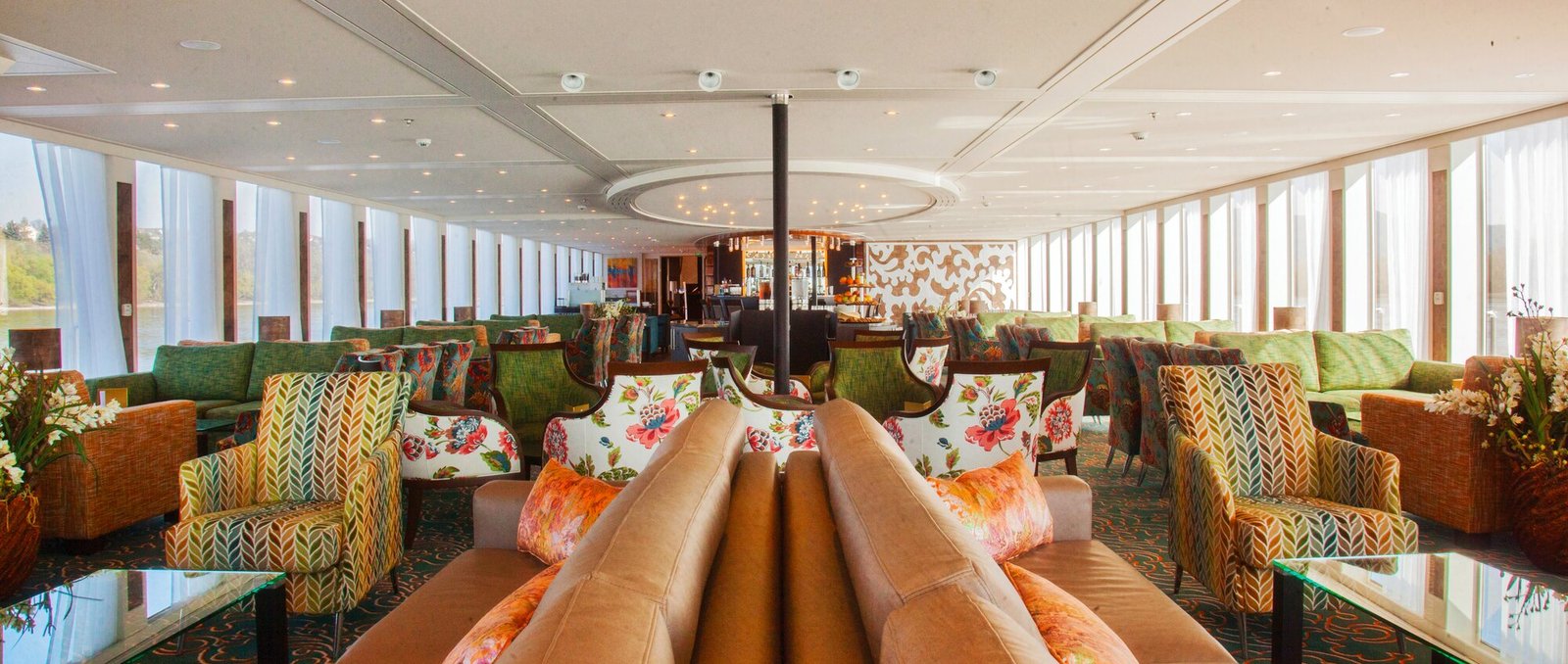 Panoramic Main Lounge and bar on AmaWaterways river ship with floor-to-ceiling river views