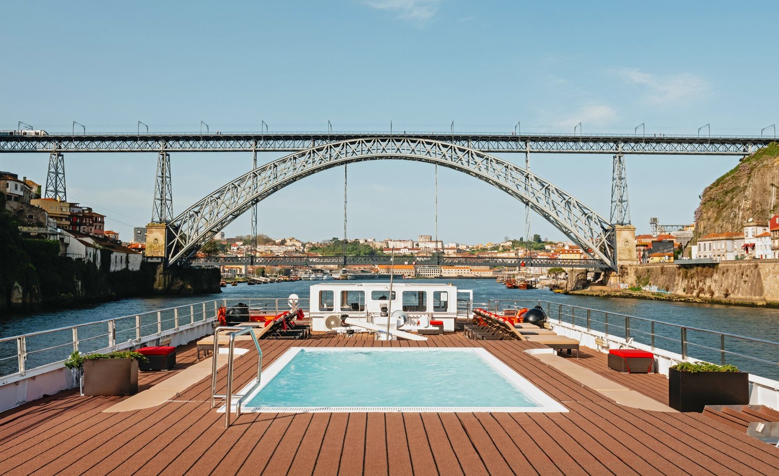 Guests relaxing by the heated Sun Deck pool and swim-up bar on AmaWaterways