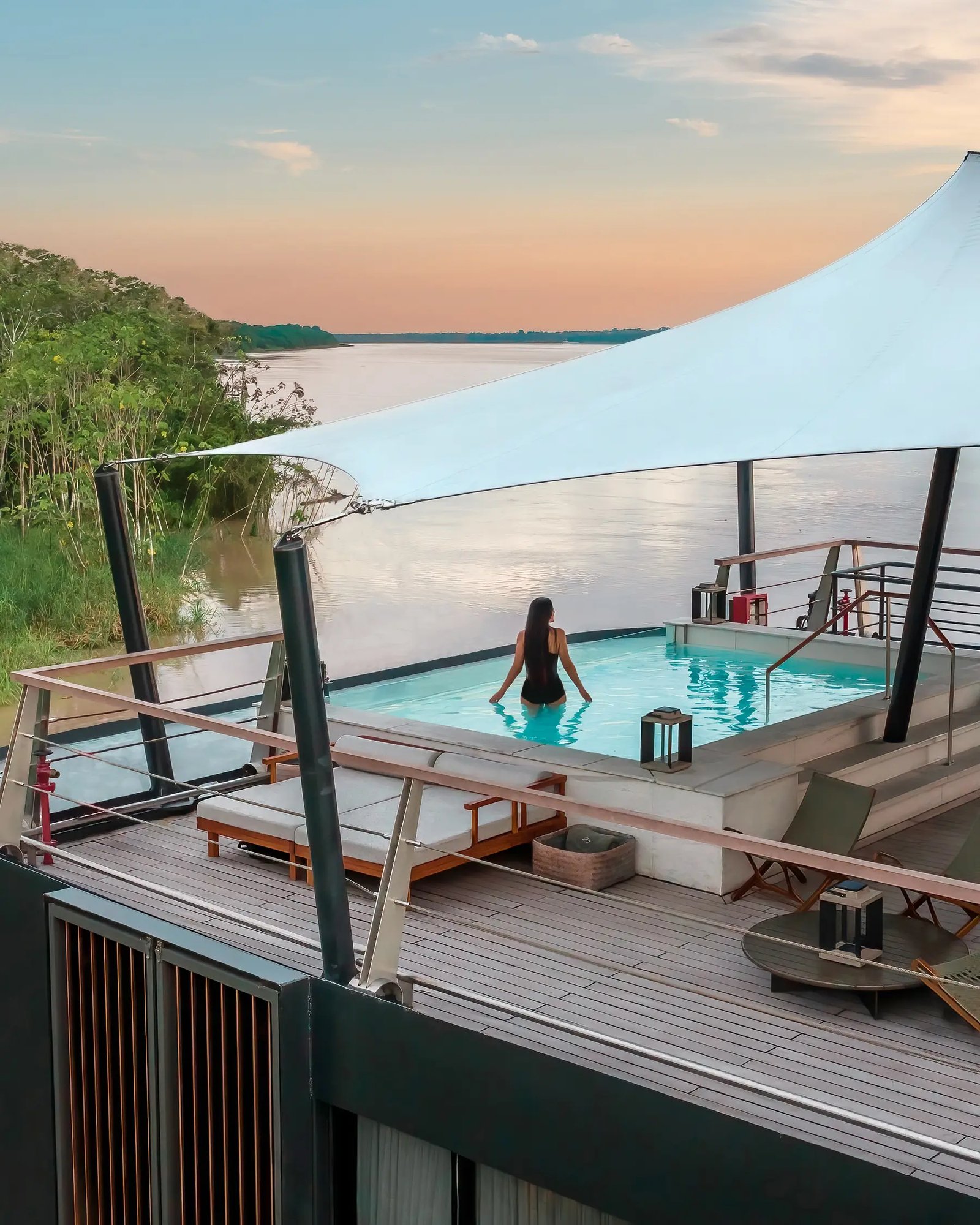 Top deck plunge pool and shaded daybeds overlooking the Amazon River on Aqua Nera