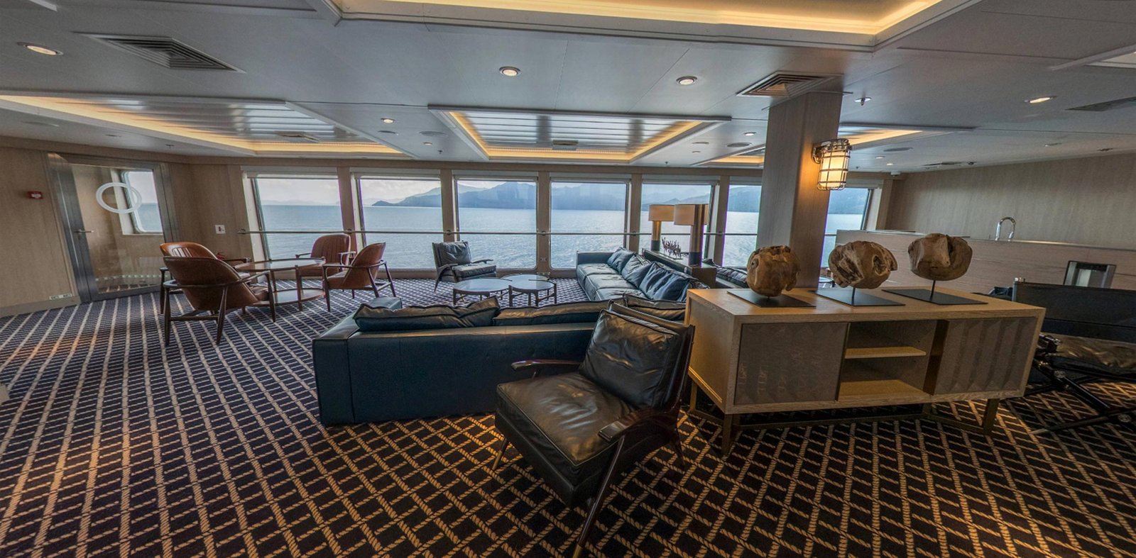 Sky Lounge on Ventus Australis with floor-to-ceiling panoramic windows and all-inclusive open bar