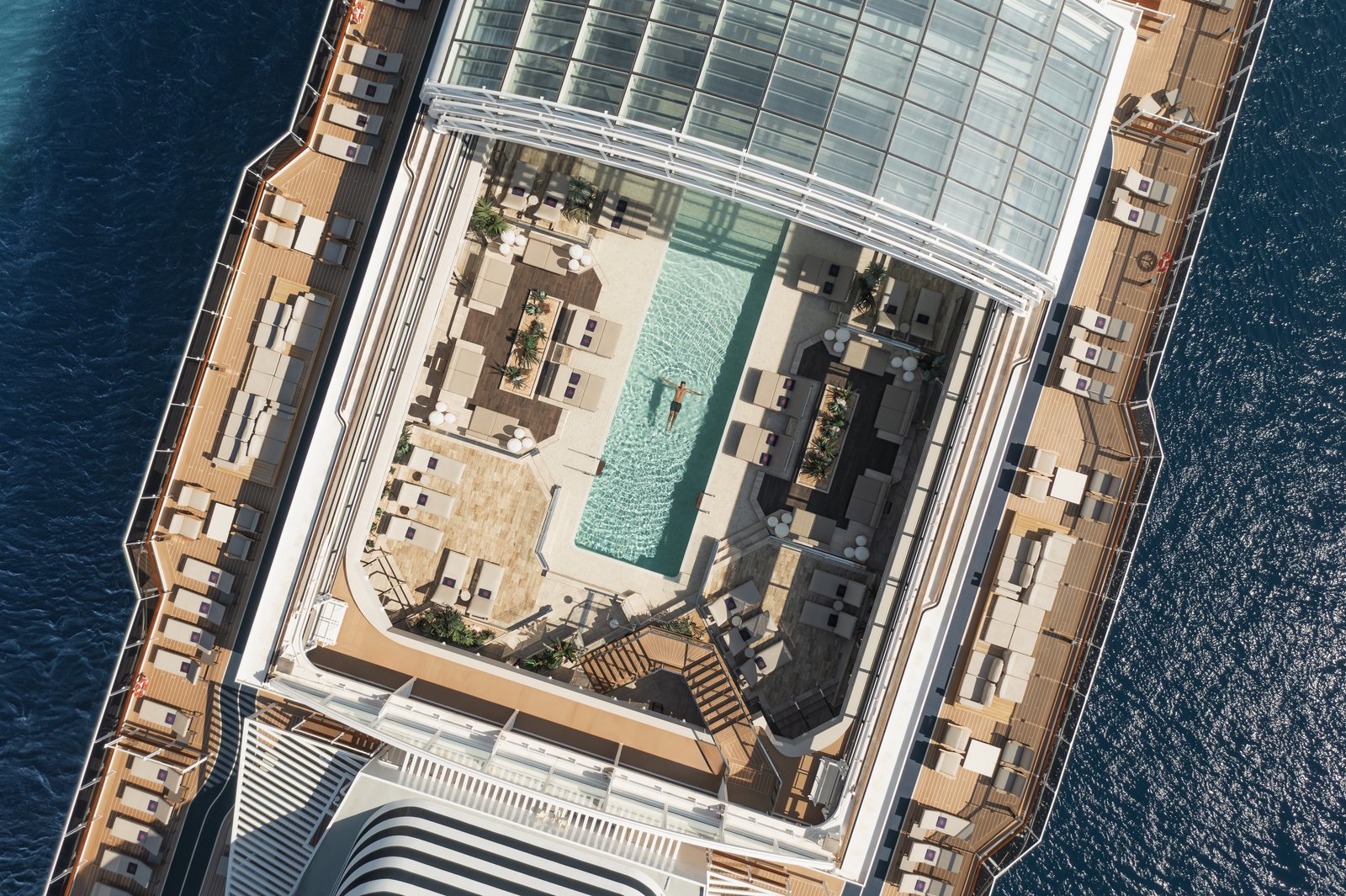 Explora Journeys Conservatory Pool with retractable glass roof and poolside loungers