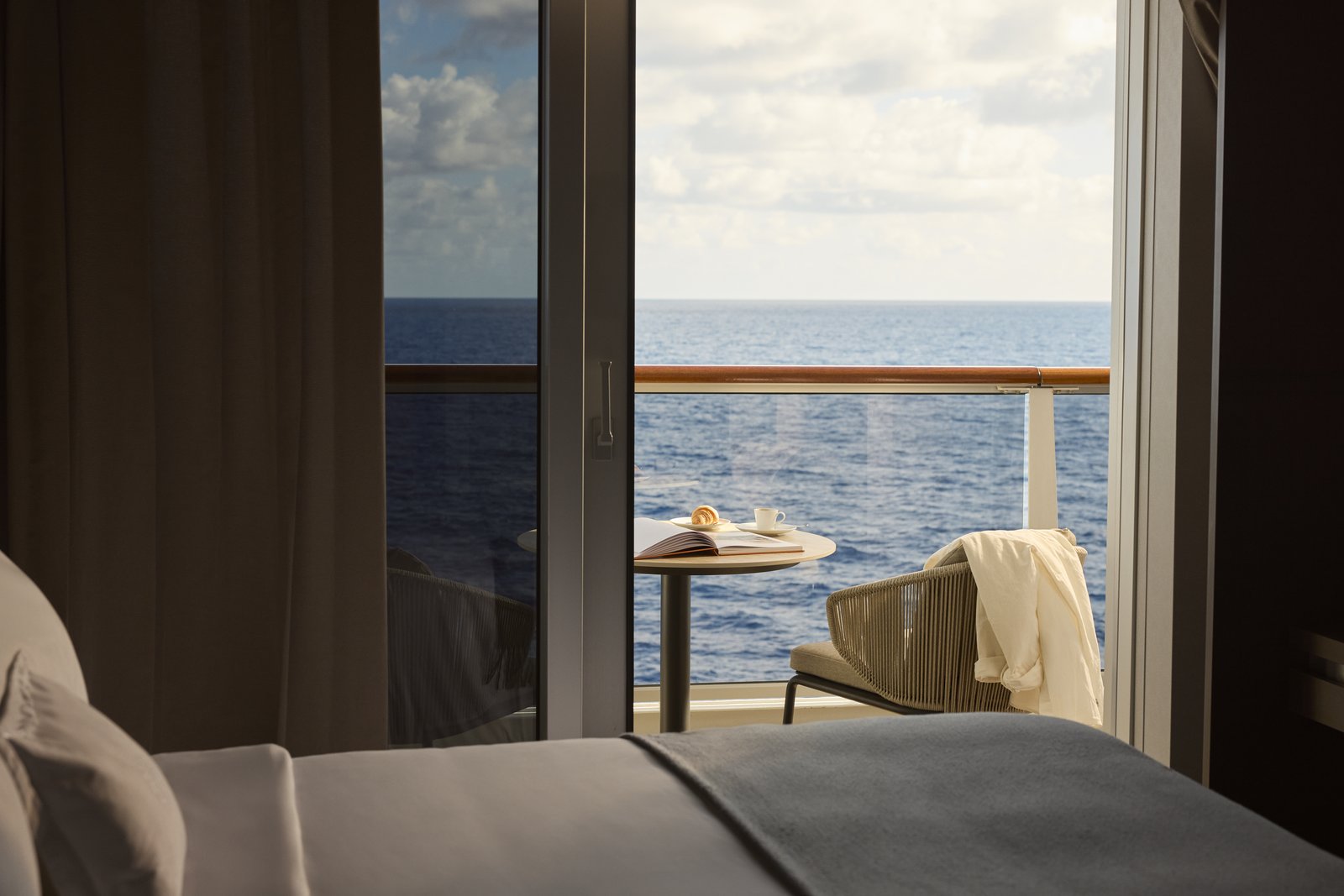 Explora Journeys Grand Penthouse private oceanfront terrace with daybed and dining table