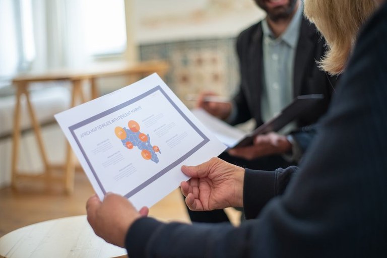 Travel advisor presenting a tiered upfront group planning retainer proposal during a client consultation