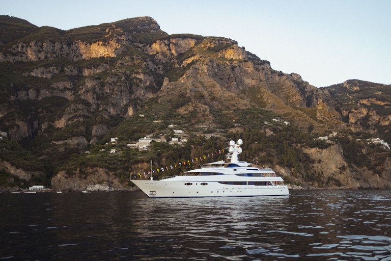 Private luxury yacht anchored along the Amalfi Coast representing bespoke culinary and Mediterranean niche travel curation