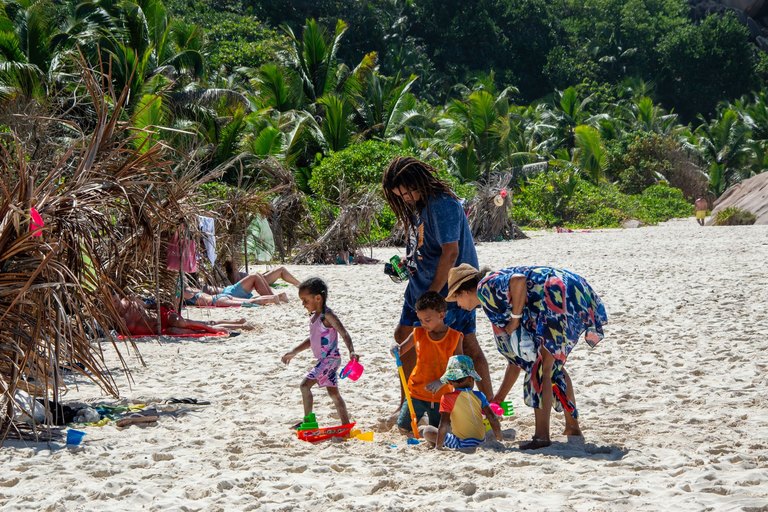 Multi-generational family celebrating a milestone anniversary reunion on a tropical beach resort vacation
