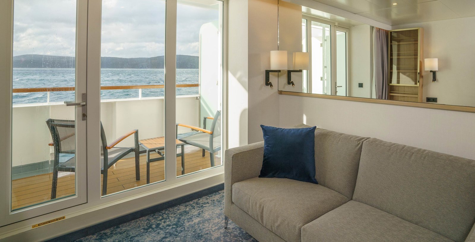 Quark Ultramarine Balcony Suite interior with comfortable sitting couch and desk
