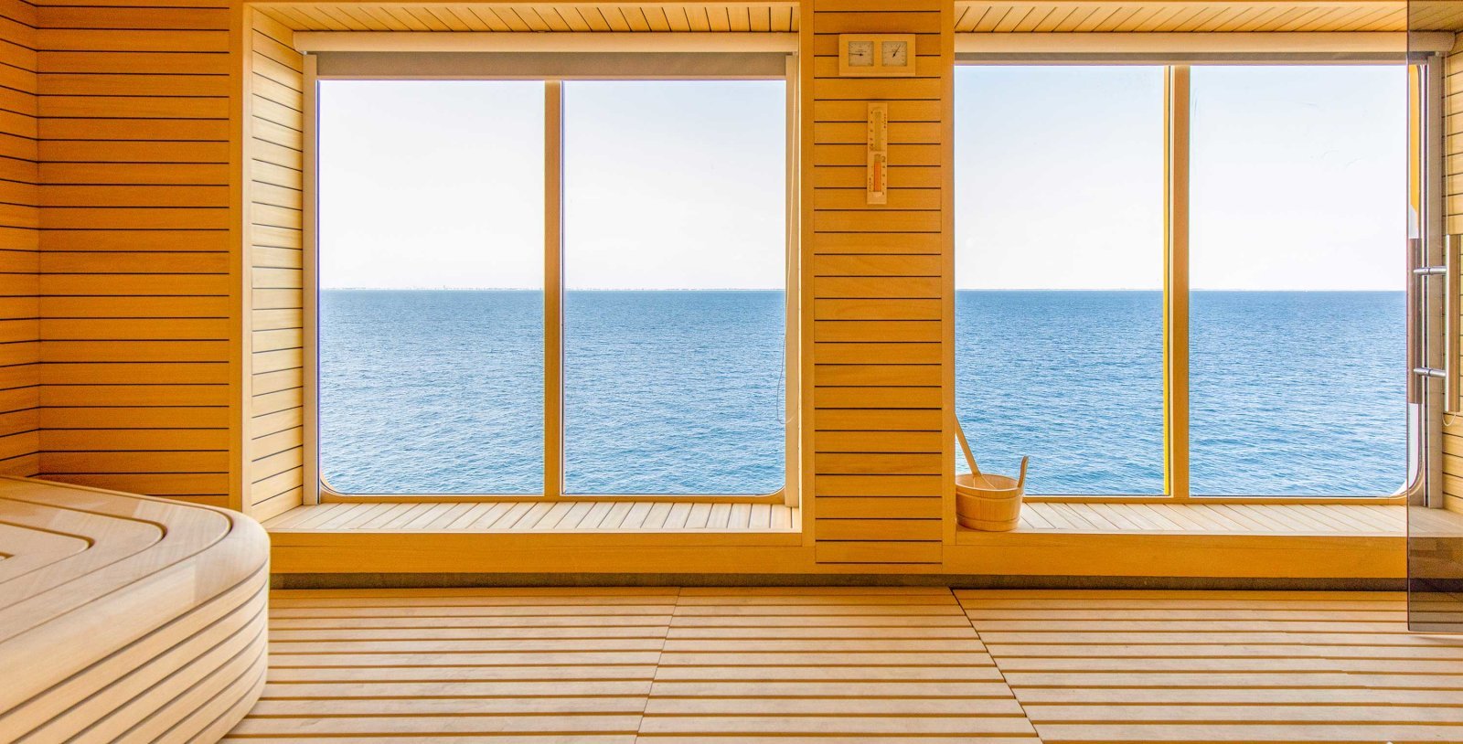 Quark Ultramarine Tundra Spa sauna with floor-to-ceiling polar ocean glass window