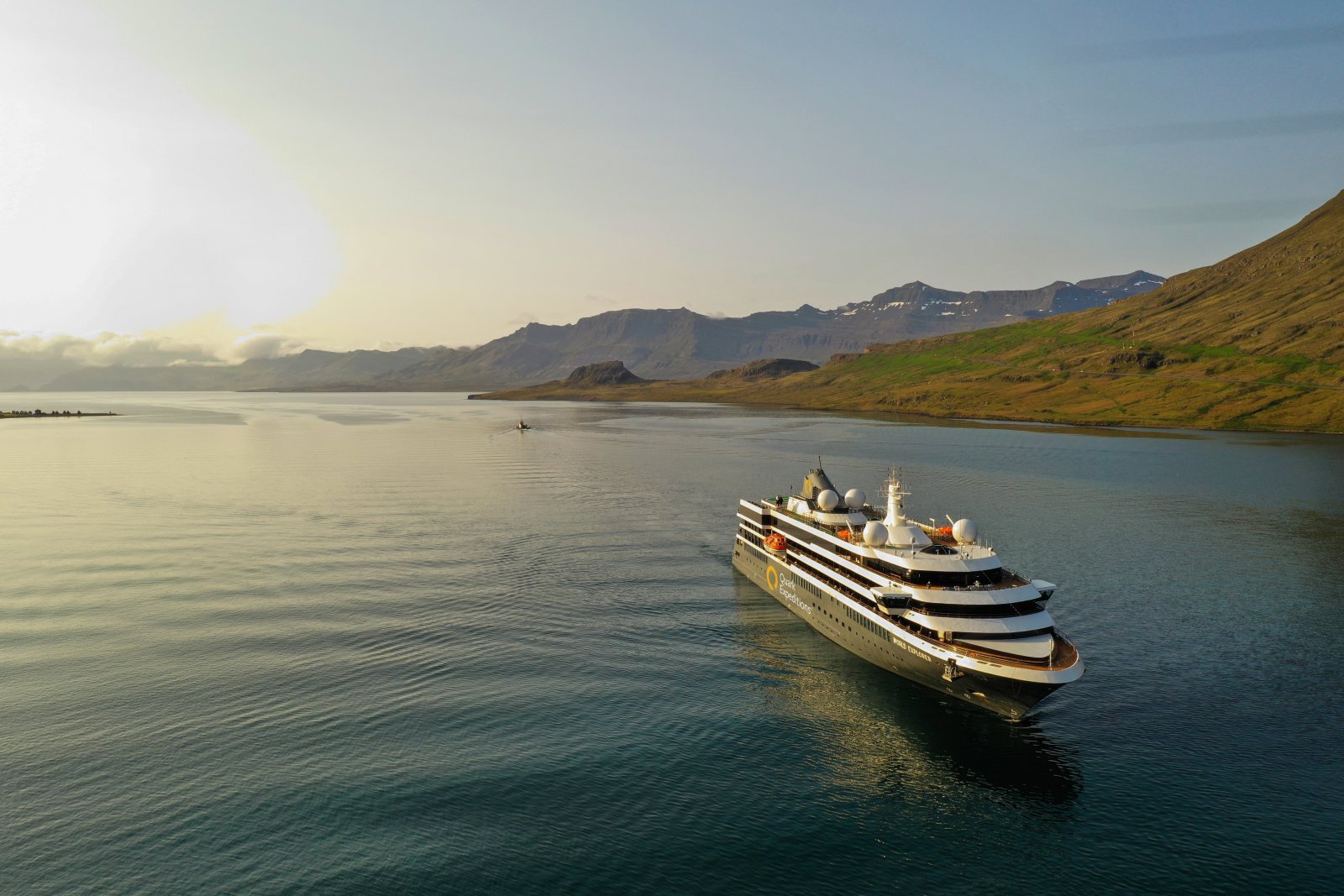 World Explorer polar expedition ship sailing past glacial cliffs