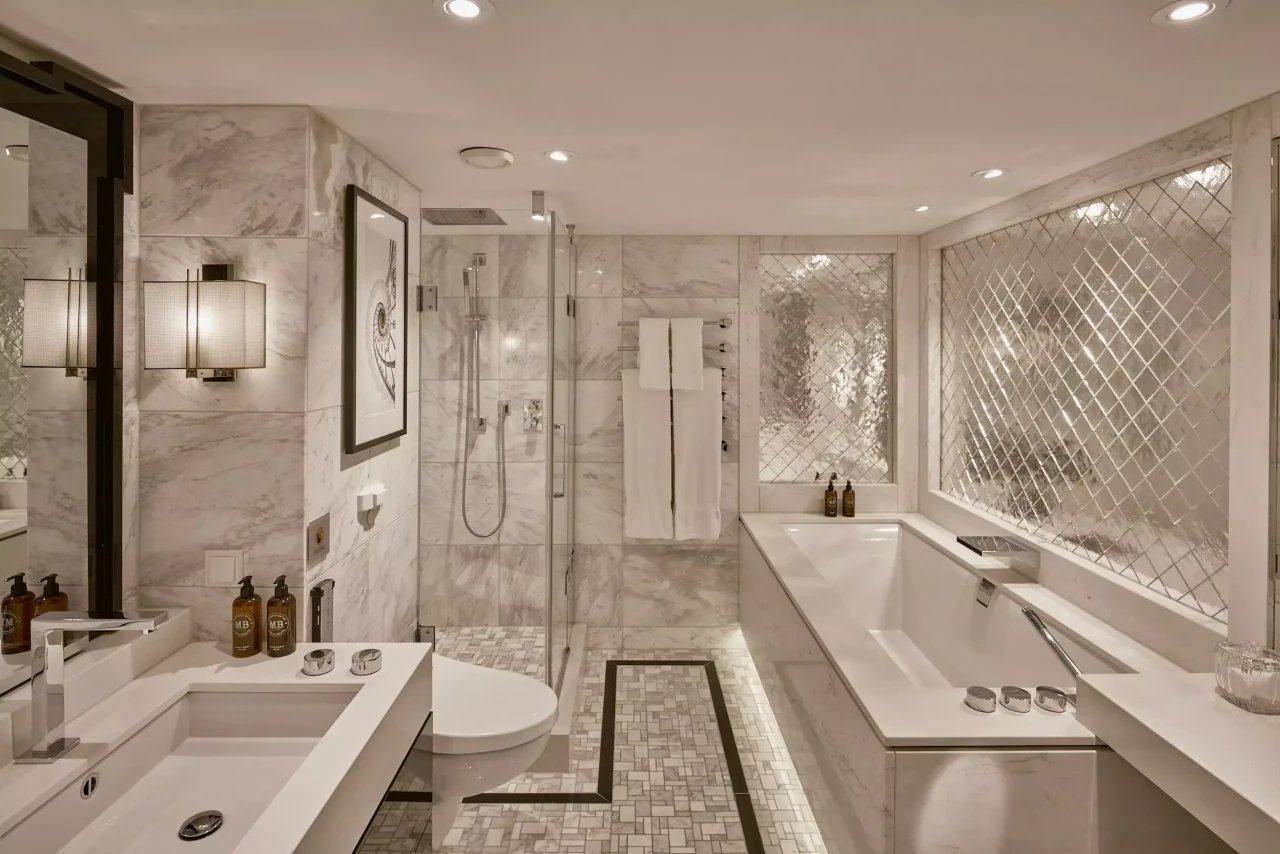 Owner's Suite master bedroom with plush king-size bed facing the French balcony