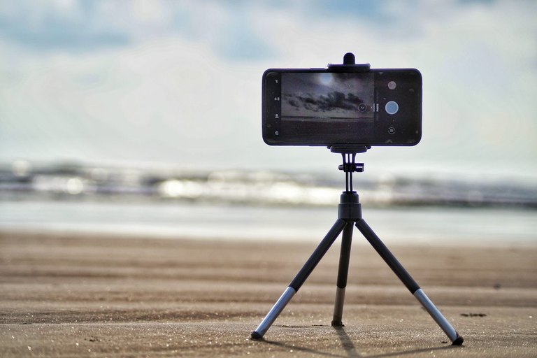 Travel advisor recording a short-form vertical video Reel and managing social media engagement on a smartphone