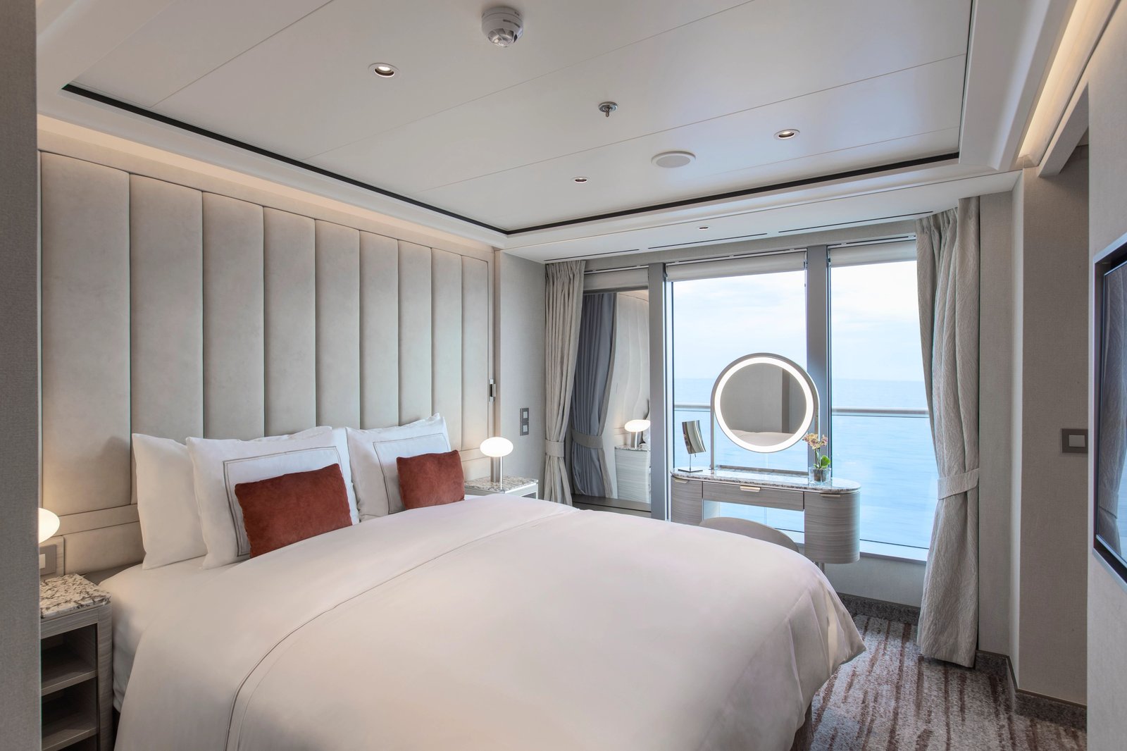Silversea Silver Nova master suite bedroom with custom Otium luxury bedding and floor-to-ceiling sea views