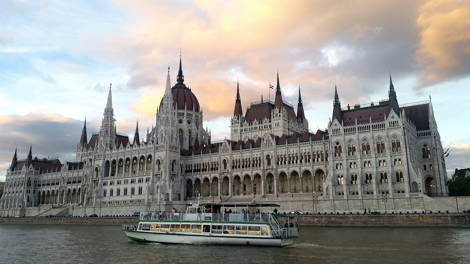 Hungarian Parliament Building in Budapest illuminated at sunset along the Danube River