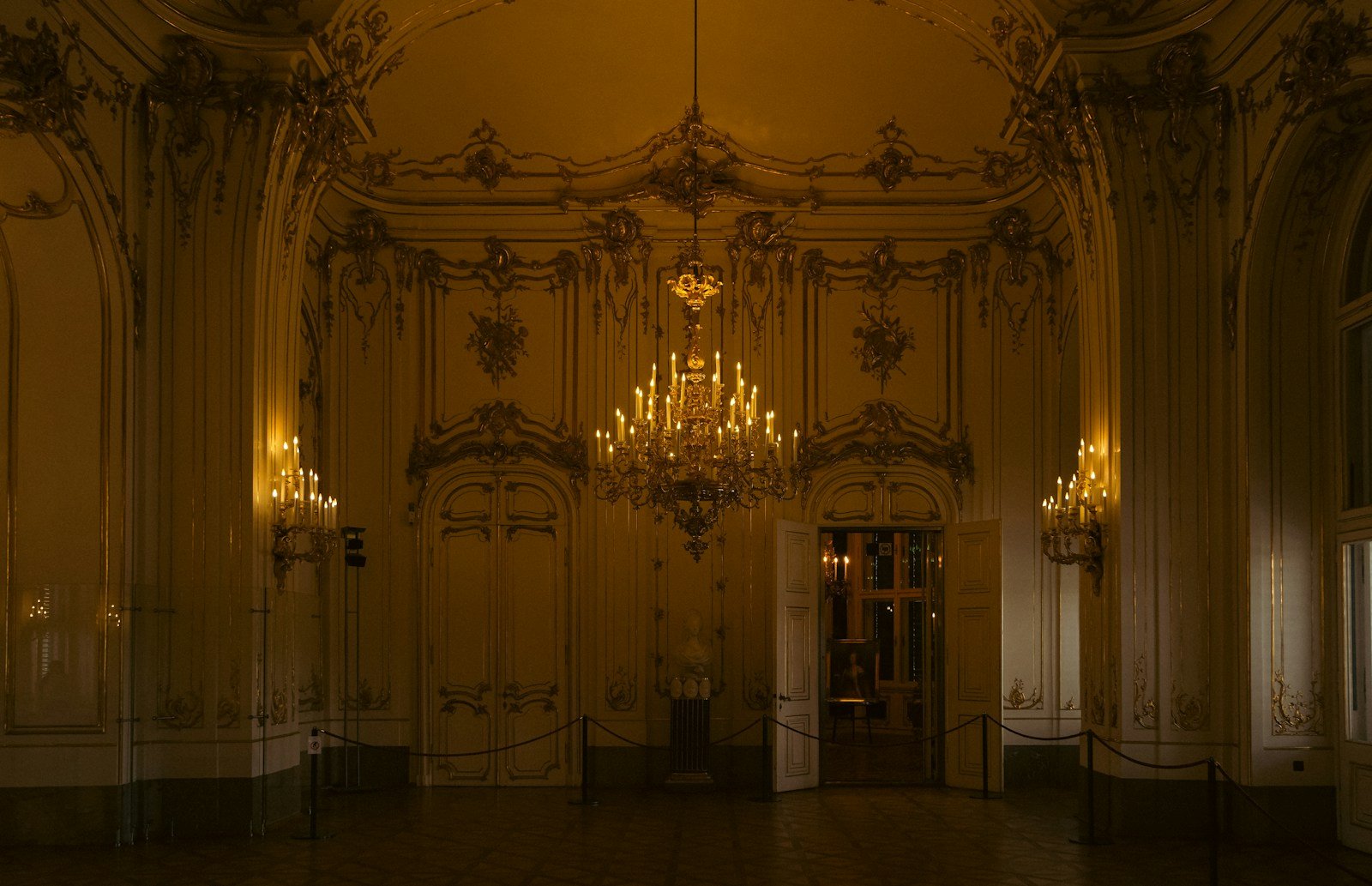 Opulent historic ballroom in Vienna with gilded ceilings and chandeliers for Tauck's exclusive private palace evening