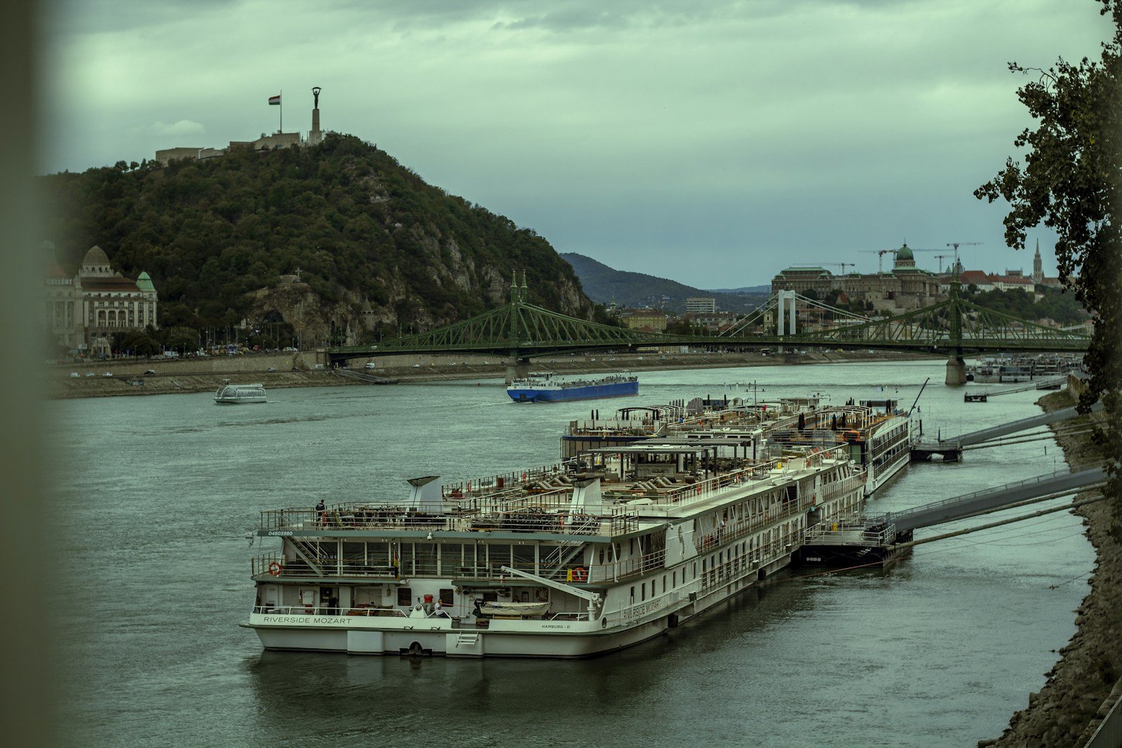 Tauck luxury riverboat moored at a picturesque European riverside town at twilight