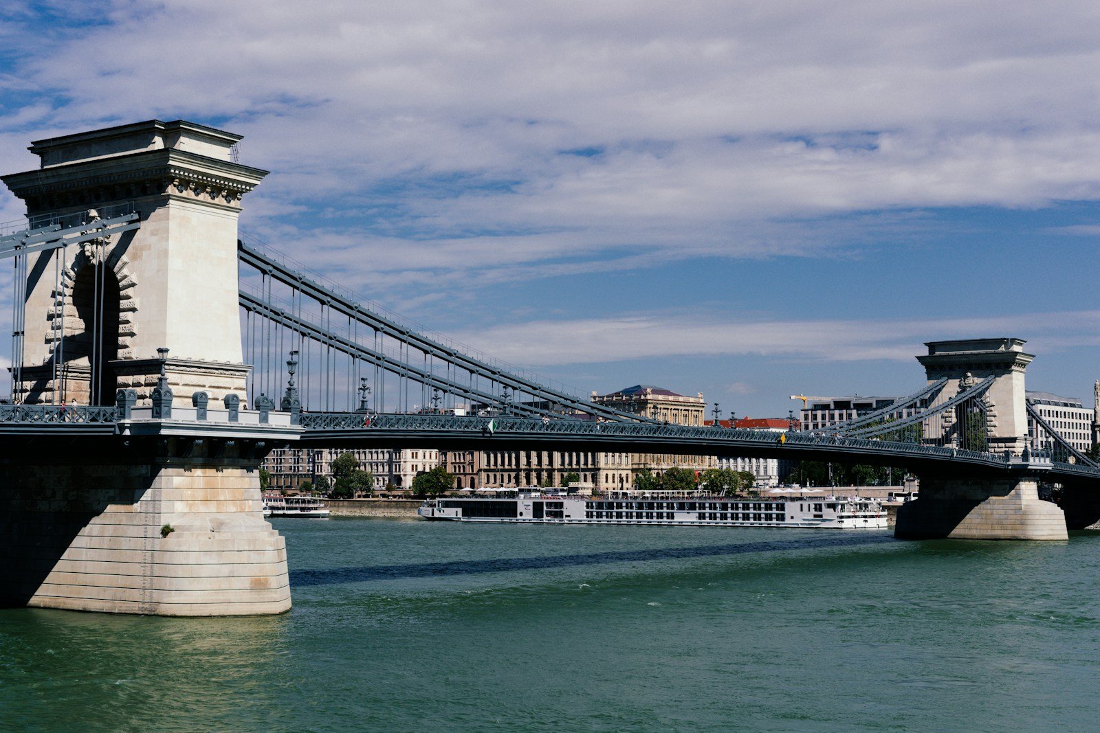 Tauck river cruise vessel cruising peacefully down the Danube River with sun deck loungers
