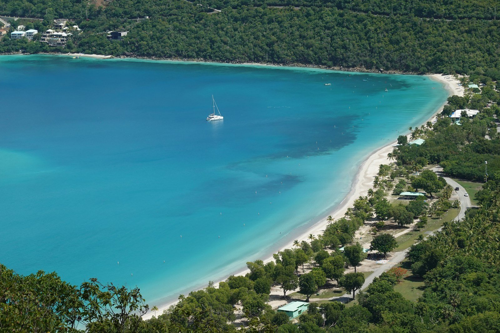 The Moorings catamaran anchored in a picturesque bay in the Virgin Islands surrounded by green hills