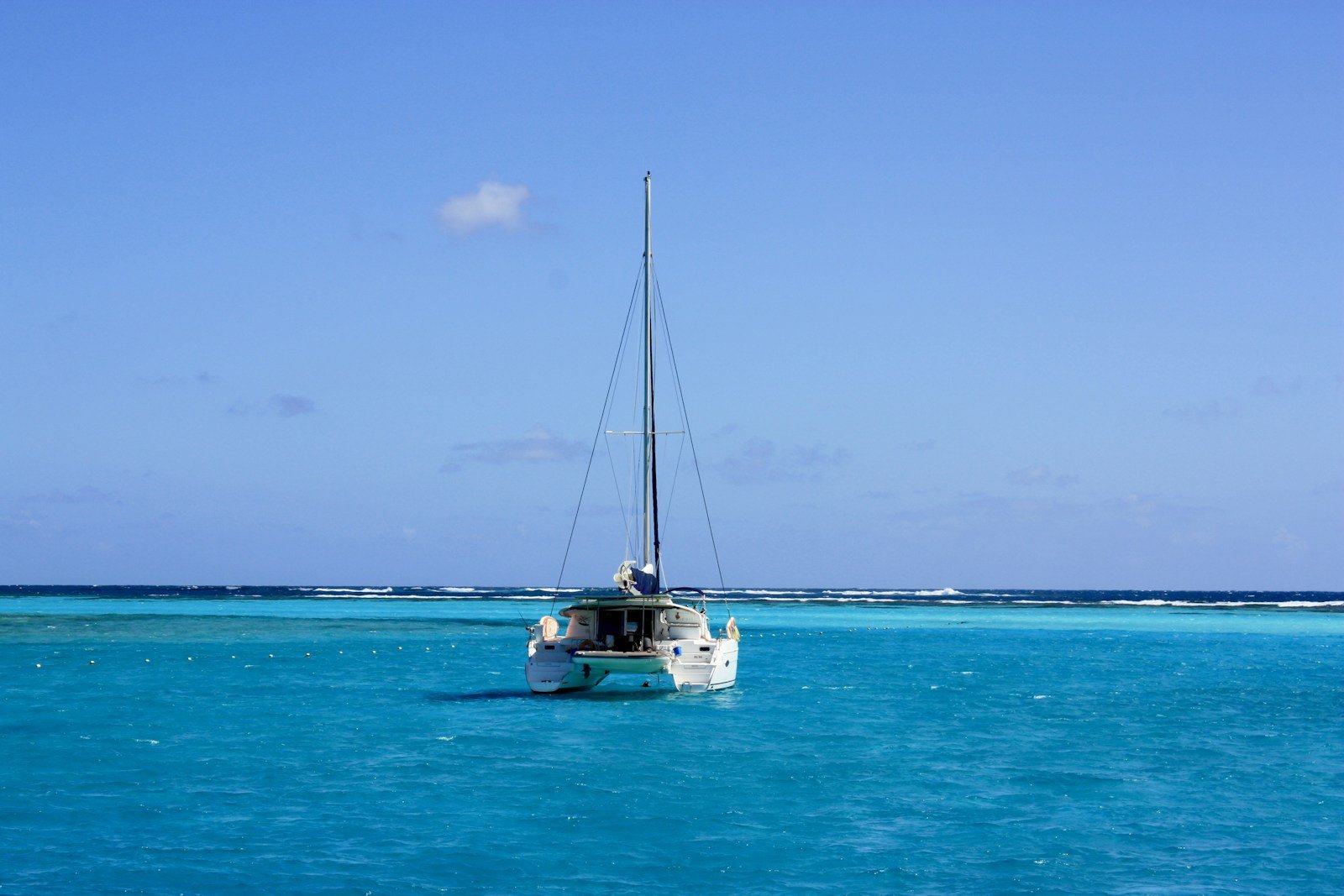 The Moorings luxury sailing catamaran gliding under full sail across crystal-clear turquoise Caribbean waters