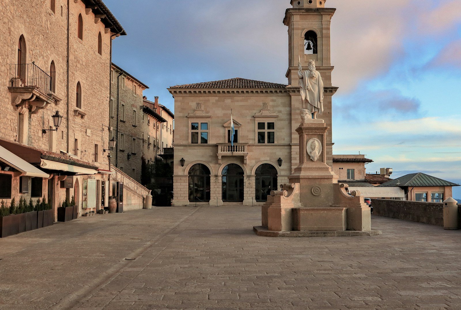 A picturesque European village with stone bell tower and historical buildings during a Trafalgar visit