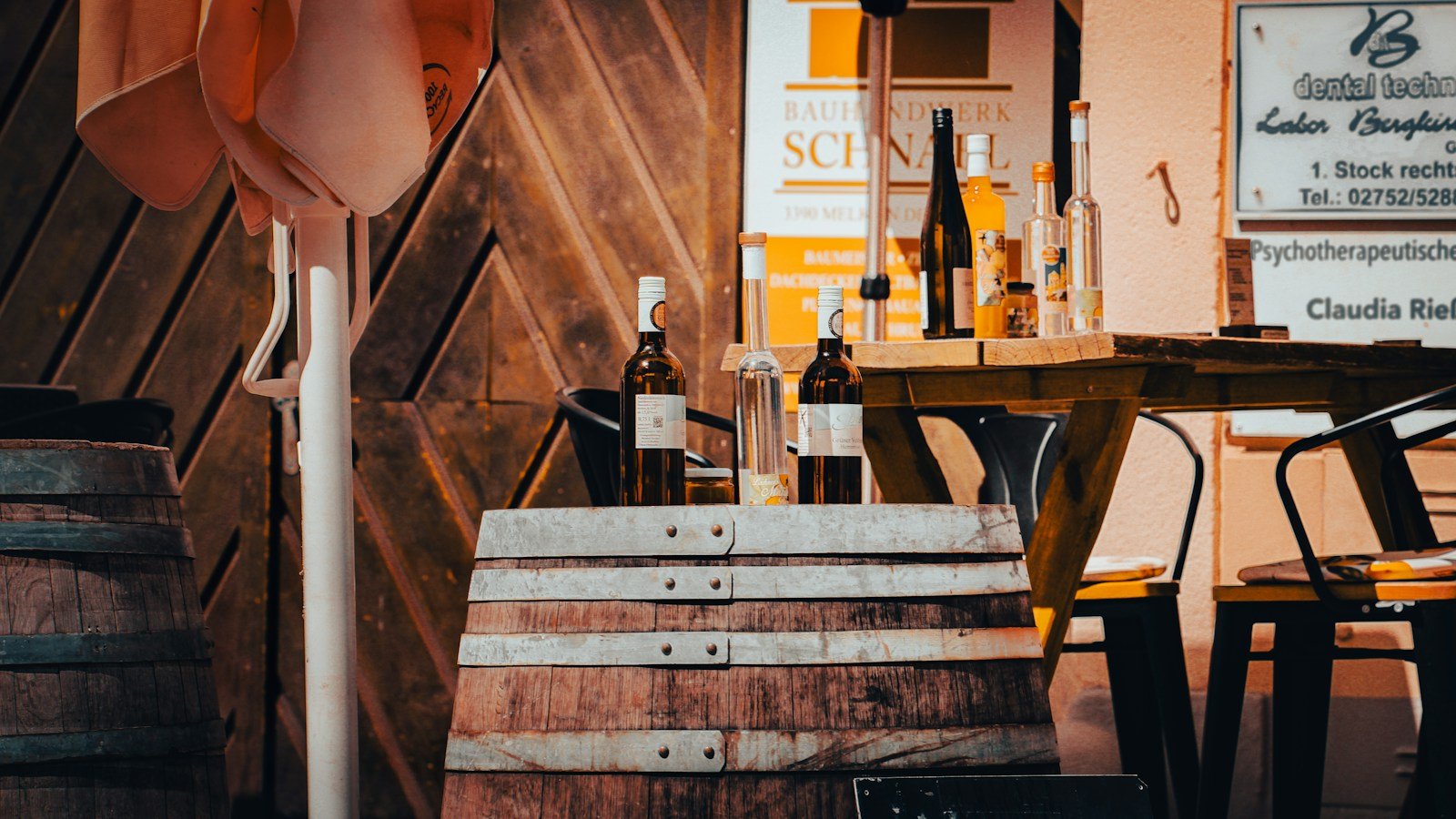 Rustic wine cellar with oak barrels and vintage wine bottles during a private tasting session