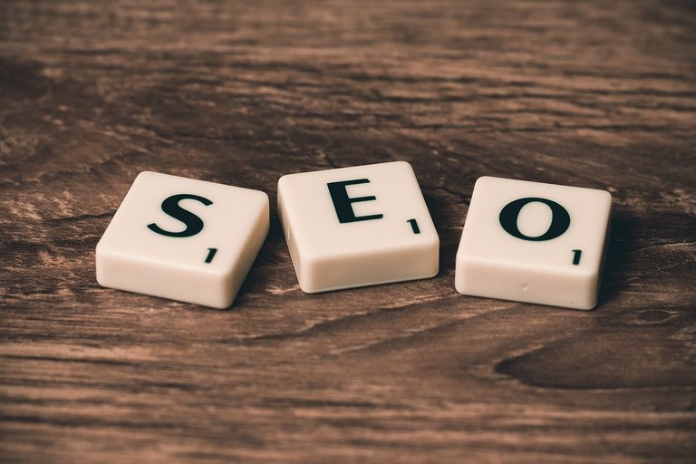 Travel advisor optimizing Google Business Profile reviews, SEO blog content, and YouTube destination walkthroughs on a laptop