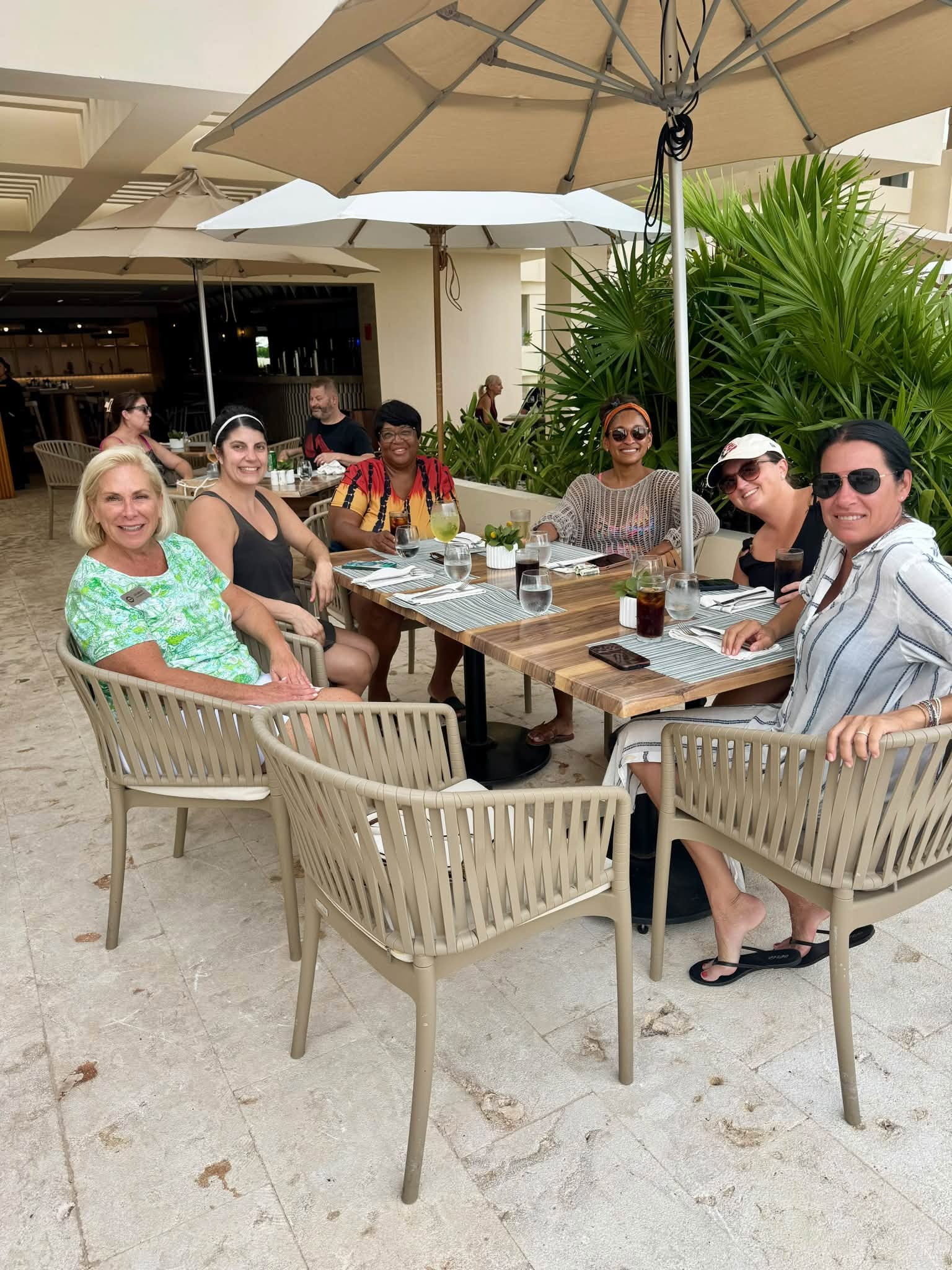 Vincent Vacations advisors enjoying a collaborative outdoor terrace lunch at Secrets Mirabel