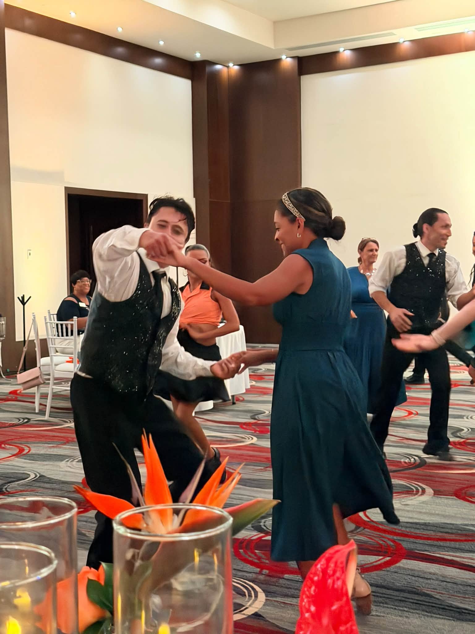 Advisors and professional dancers celebrating on the dance floor at the Vincent Vacations Farewell Gala