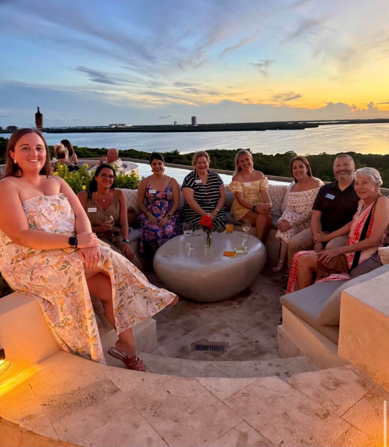 Advisors enjoying golden hour sunset cocktails at the Secrets Mirabel rooftop infinity lounge