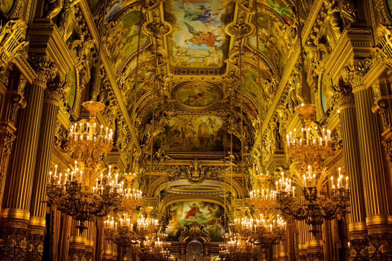Grand two-story palace foyer with sweeping wrought-iron staircase and classical European architecture