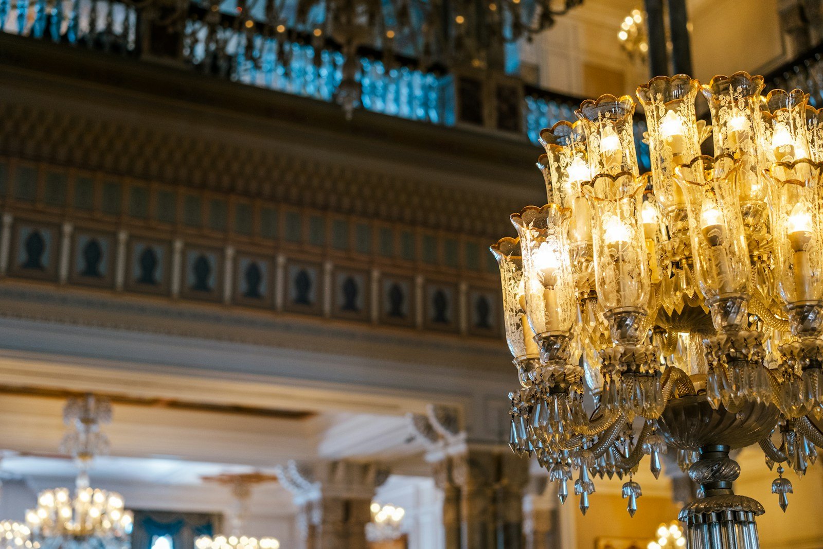 Opulent Uniworld Royal Suite salon illuminated by an authentic crystal chandelier with gilded European furnishings