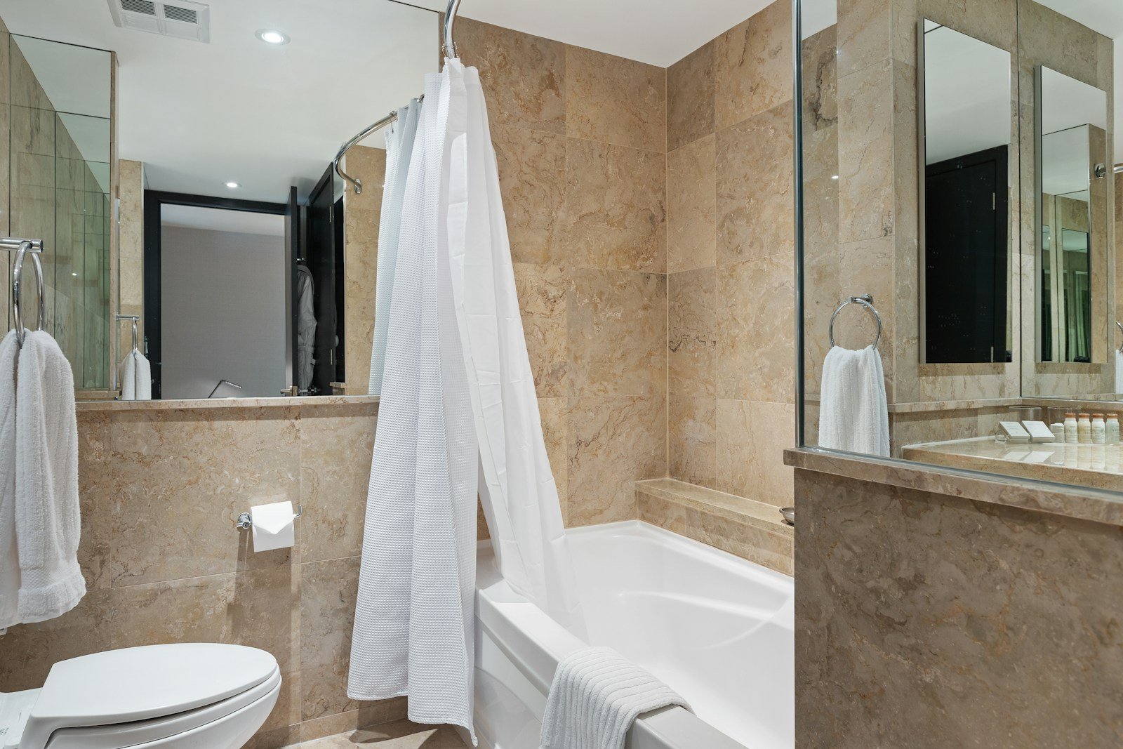 Freestanding soaking tub in a luxury river cruise bathroom with high-end Asprey of London bath amenities