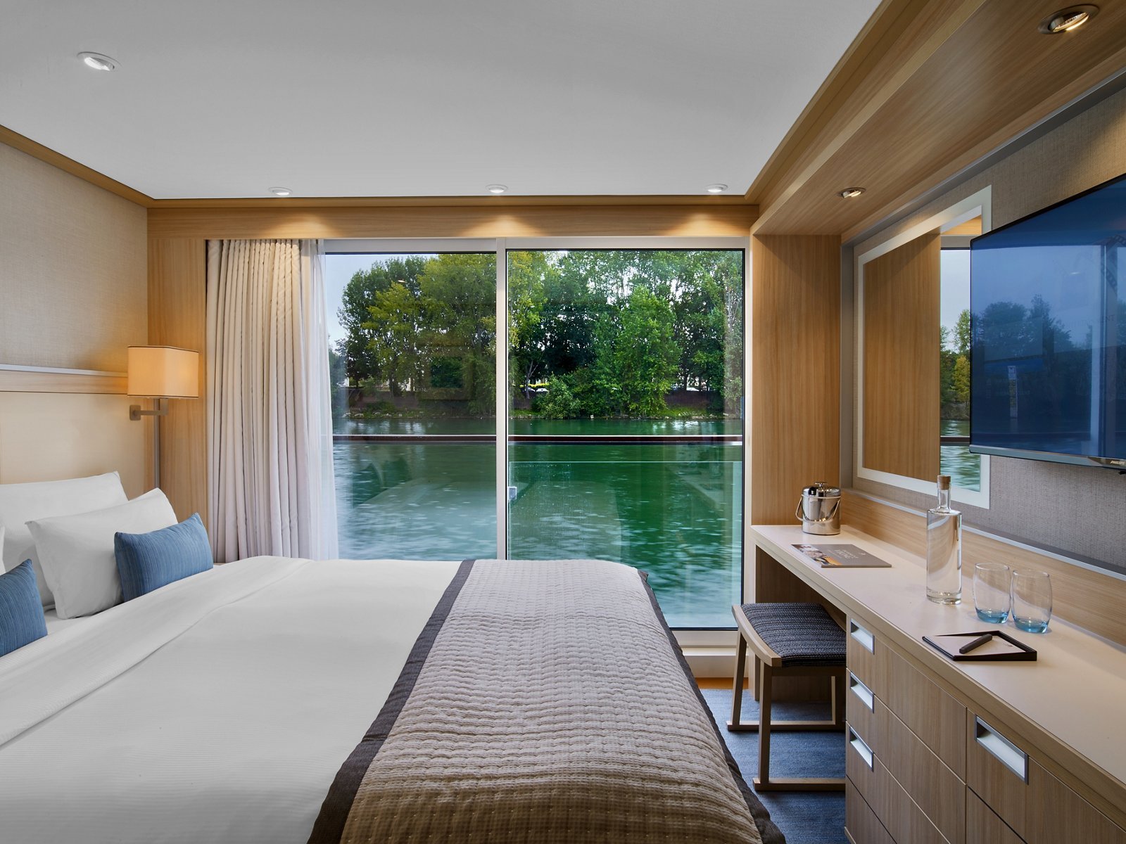 Viking Longship French Balcony Stateroom with floor-to-ceiling sliding glass doors opening to European river views